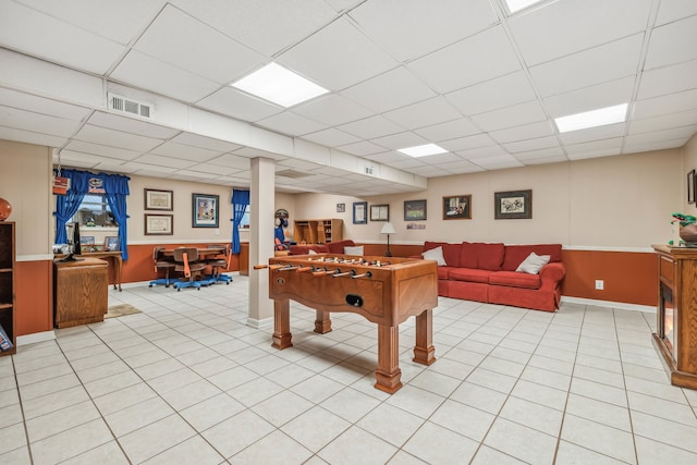 rec room with a drop ceiling and light tile patterned floors