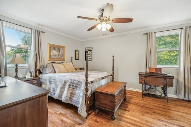 bedroom with multiple windows, crown molding, ceiling fan, and light hardwood / wood-style flooring