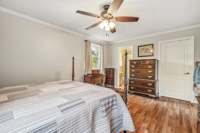 bedroom featuring wood-type flooring, crown molding, ensuite bath, and ceiling fan