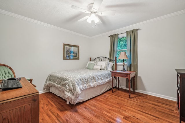 bedroom with ceiling fan, ornamental molding, and hardwood / wood-style floors