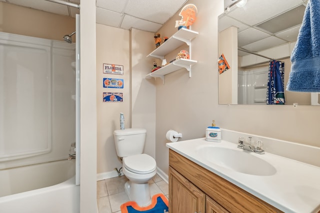 full bathroom with tile patterned flooring, vanity, toilet, and a drop ceiling