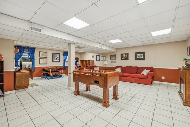 playroom featuring light tile patterned flooring and a paneled ceiling