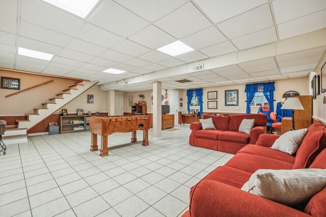 playroom featuring light tile patterned flooring and a paneled ceiling