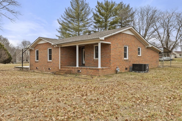 view of home's exterior with central AC unit, a lawn, and covered porch