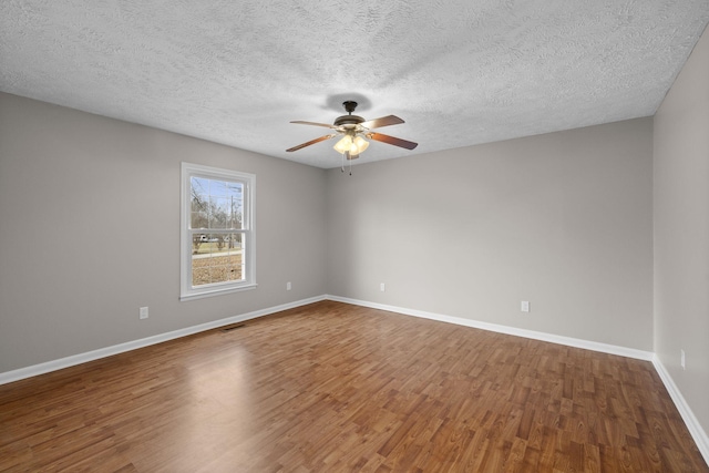 unfurnished room with wood-type flooring, a textured ceiling, and ceiling fan