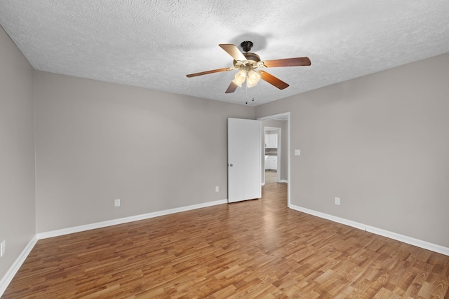 spare room featuring ceiling fan, a textured ceiling, and light hardwood / wood-style floors