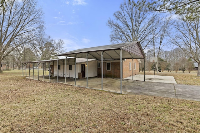 exterior space featuring a carport and a yard