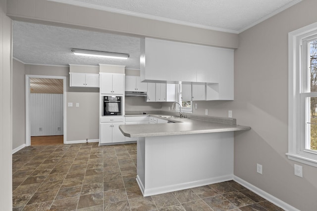 kitchen with sink, crown molding, white cabinetry, black appliances, and kitchen peninsula