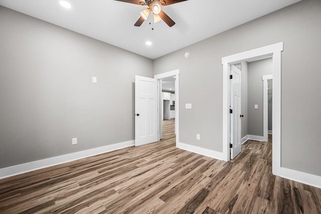 unfurnished bedroom with hardwood / wood-style floors and ceiling fan