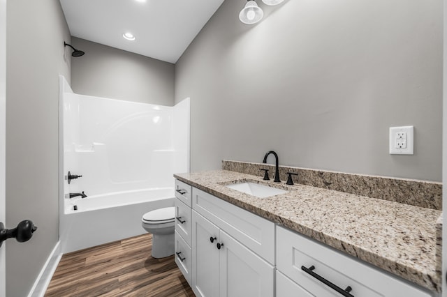 full bathroom featuring vanity, hardwood / wood-style floors, shower / bathing tub combination, and toilet