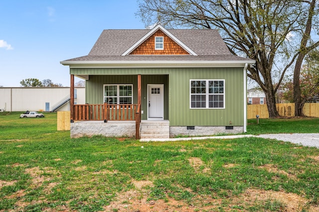 view of front facade with a front yard and covered porch