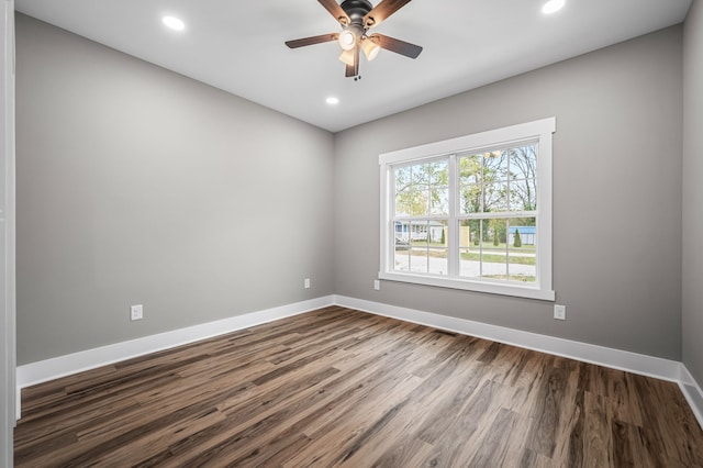 empty room featuring ceiling fan and dark hardwood / wood-style flooring