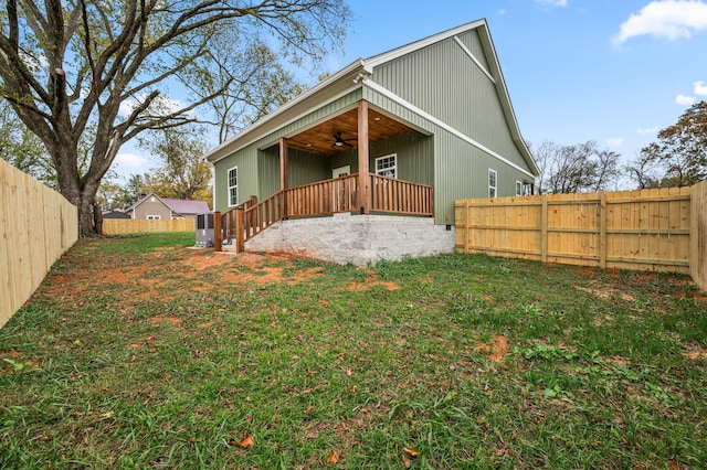 exterior space featuring a yard and ceiling fan