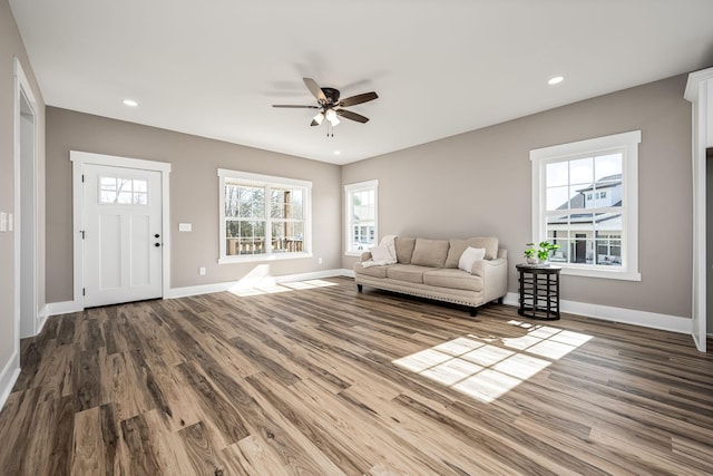 unfurnished living room featuring ceiling fan and wood-type flooring