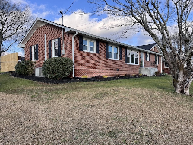 view of side of home with a yard and central air condition unit