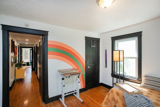 home office featuring a textured ceiling and hardwood / wood-style flooring