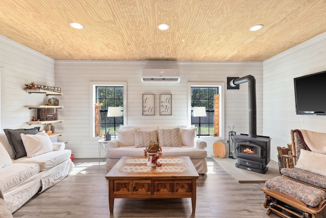 living room featuring wood ceiling, a wood stove, and hardwood / wood-style floors