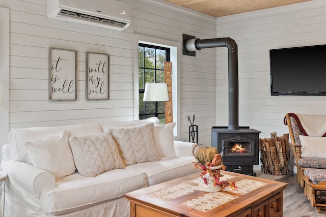 living room featuring a wood stove, wooden ceiling, wood-type flooring, wooden walls, and a wall mounted AC