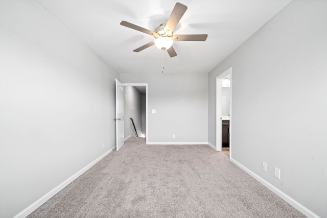 unfurnished bedroom featuring connected bathroom, ceiling fan, and light colored carpet