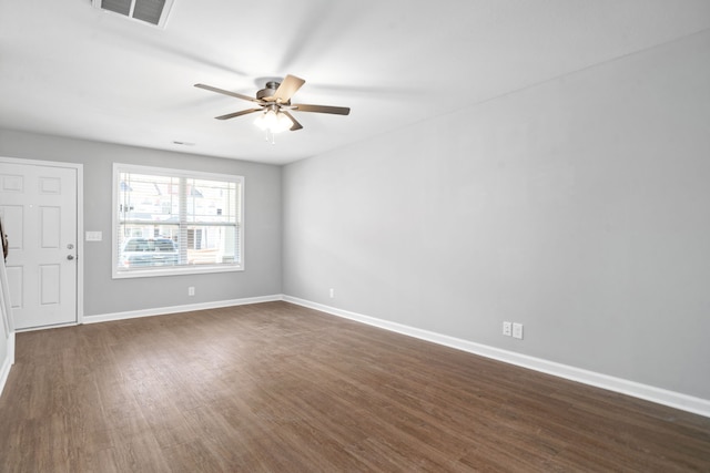 spare room featuring ceiling fan and dark hardwood / wood-style floors