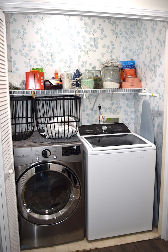 clothes washing area featuring wood-type flooring and separate washer and dryer