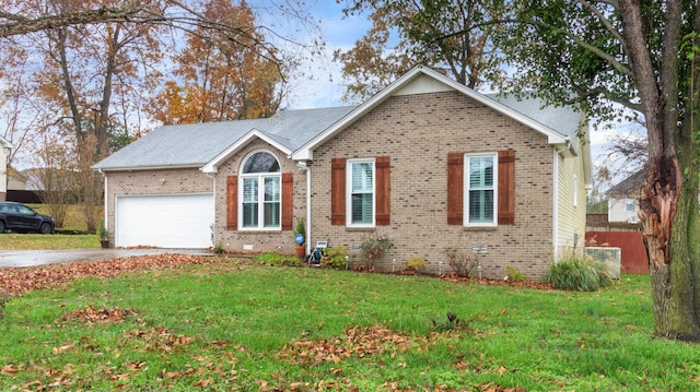 view of front of house featuring a front yard and a garage