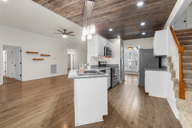 kitchen with white cabinets, appliances with stainless steel finishes, dark wood-type flooring, and wood ceiling