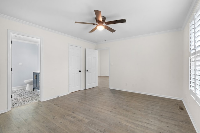 unfurnished bedroom featuring multiple windows, ceiling fan, ornamental molding, and hardwood / wood-style flooring