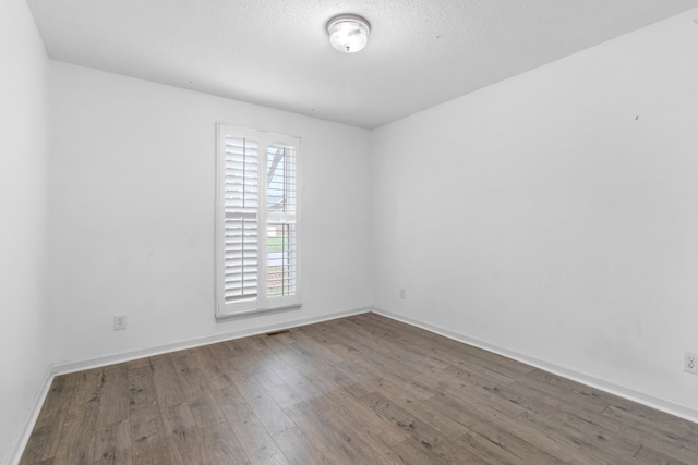 unfurnished room with dark hardwood / wood-style floors