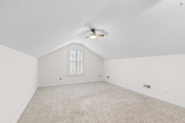 bonus room with ceiling fan, light carpet, and vaulted ceiling