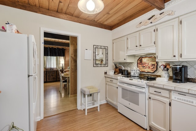 kitchen featuring light wood-type flooring, tasteful backsplash, and white appliances