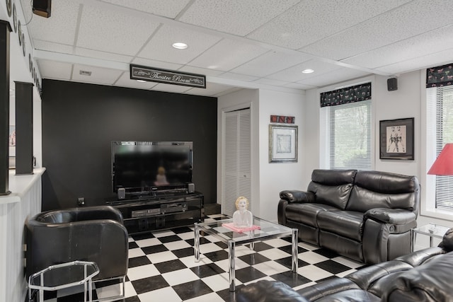 living room with a drop ceiling