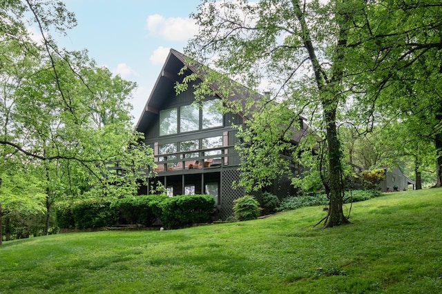 rear view of property with a lawn