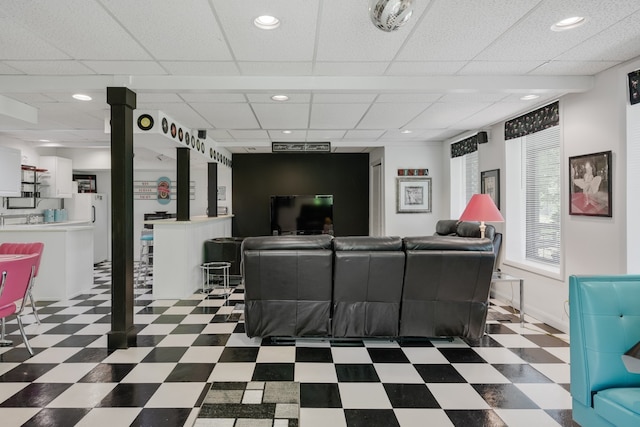 living room featuring a drop ceiling