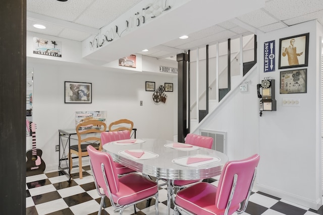 dining space with a paneled ceiling