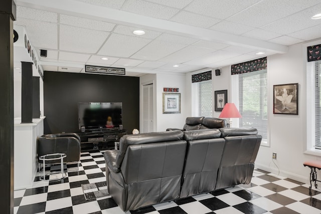 living room featuring a paneled ceiling