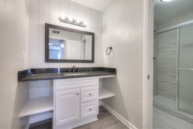 bathroom with vanity, hardwood / wood-style floors, and a shower with shower door