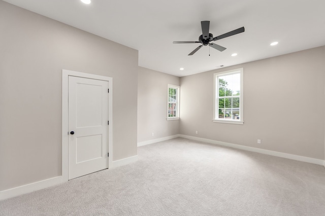 unfurnished room featuring light carpet and ceiling fan