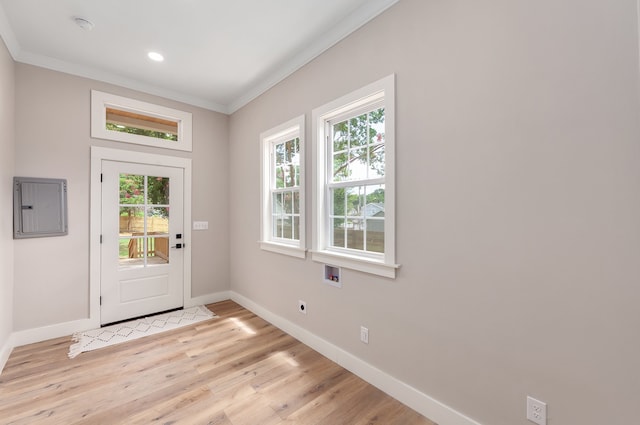 doorway to outside with light wood-type flooring, electric panel, and crown molding