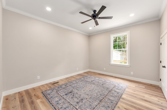 spare room with light wood-type flooring, crown molding, and ceiling fan