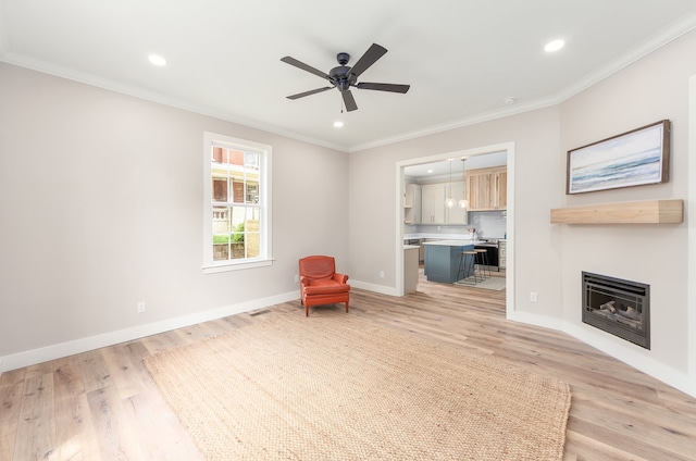 unfurnished room featuring crown molding, light hardwood / wood-style floors, and ceiling fan