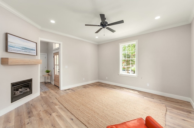 unfurnished living room featuring light hardwood / wood-style floors, ornamental molding, and ceiling fan