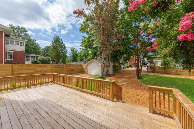 wooden terrace with a shed and a lawn