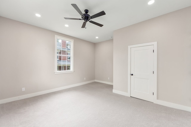 spare room with light carpet and ceiling fan