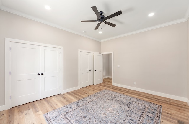 unfurnished bedroom with ceiling fan, light wood-type flooring, and ornamental molding