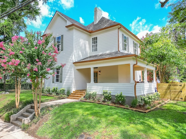 view of front of house featuring a front lawn and covered porch