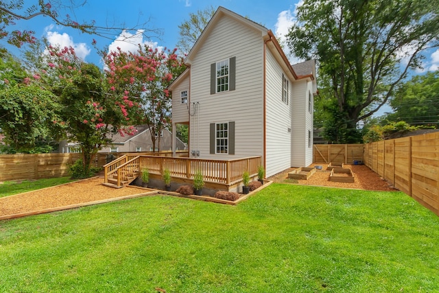 rear view of property with a lawn and a deck