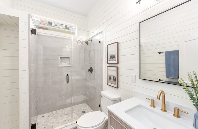 bathroom featuring wooden walls, an enclosed shower, vanity, and toilet