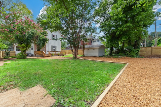 view of yard with a wooden deck and a garage