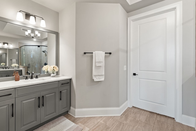 bathroom with a notable chandelier, an enclosed shower, and vanity